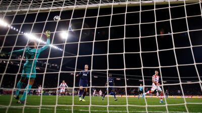 The ball deflects off Tottenham Hotspur's Davinson Sanchez and hits the crossbar after a shot from Rajiv van La Parra of Red Star Belgrade. Reuters