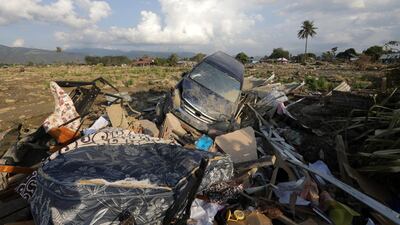 A car is stranded in the mud at Petobo village in Palu. EPA