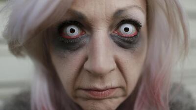 Project manager Yvonne Nagel poses for a photo while getting ready at Movie Park Germany in Bottrop October 25, 2013. Nagel, 38, will perform this year as the character 'Amanda Young' from the 'Saw' horror film series for the "Halloween Horror Party 2013" at Movie Park Germany. Ina Fassbender / Reuters