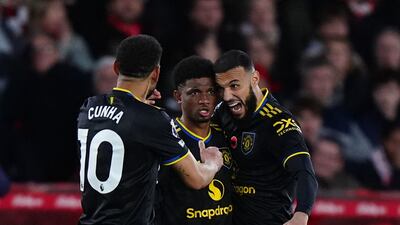 Manchester United's Amad Diallo, centre, celebrates with teammates Matheus Cunha, left, and Noussair Mazraoui after scoring against Nottingham Forest on Saturday, November 1, 2025. AP