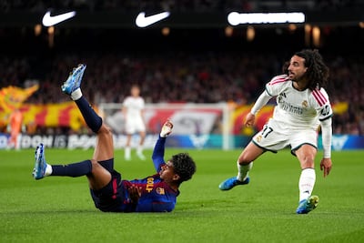 Barcelona winger Lamine Yamal goes to ground after a challenge by Real Madrid defender Marc Cucurella. Getty Images
