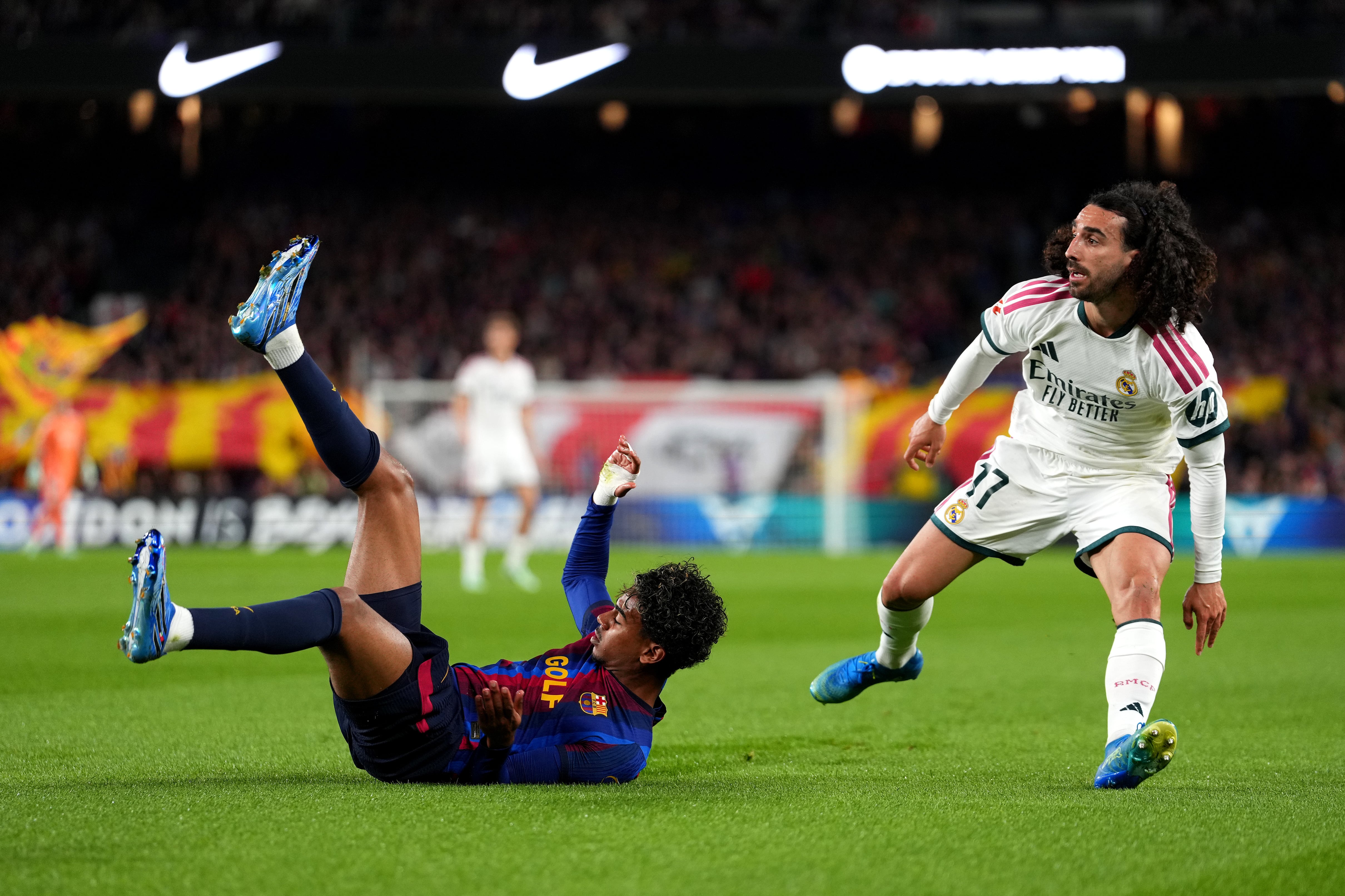 Barcelona winger Lamine Yamal goes to ground after a challenge by Real Madrid defender Marc Cucurella. Getty Images