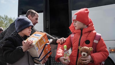 Nine-year-old Galina, right, and Nazar, 8, arrive with their families in Raihorodok. AFP
