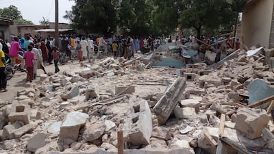 People gather at the site of a suicide bomb attack in Maiduguri, Nigeria on July 17, 2017. Jossy Ola / AP