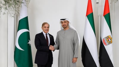 ABU DHABI, UNITED ARAB EMIRATES - January 12, 2023: HH Sheikh Mohamed bin Zayed Al Nahyan, President of the United Arab Emirates (R) and HE Shehbaz Sharif, Prime Minister of Pakistan (L), stand for a photograph prior to a meeting, at Al Shati Palace. ( Hamad Al Kaabi / UAE Presidential Court ) ---