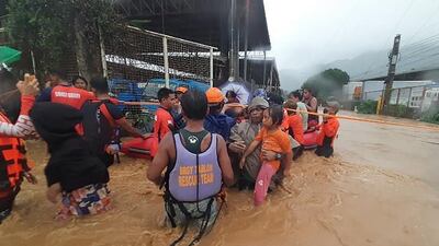 Residents are helped to higher grounds. Photo: AFP