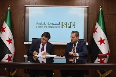 Richard Hall, chief executive of Dana Gas, left, signing the agreement with the Syrian Petroleum Company. Photo: Dana Gas