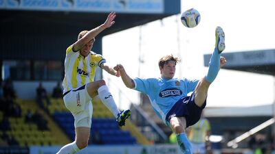 Billy Bingham of Dagenham & Redbridge, right, clears the ball under pressure from Lee Mansell of Torquay United during the Sky Bet League Two match in England. Dan Mullan / Getty Images