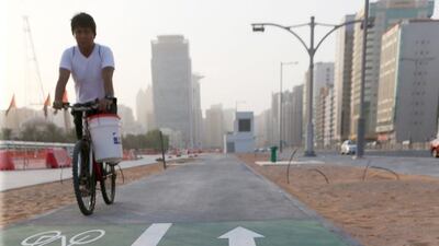 A cyclist rides on a new bicycle path along Sheikh Zayed Bin Sultan street at the intersection of Al Falah street in the Al Danah area of Abu Dhabi. Christopher Pike / The National