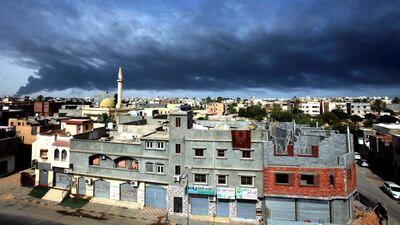 Smoke fills the sky over Tripoli after rockets fired by a militia struck a tank in the capital's main fuel depot. Sabri Elmhedwi / EPA
