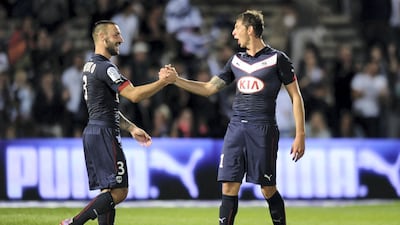 Bordeaux's Diego Contento (L) and Emiliano Sala (R) celebrate at the end of the French L1 football match Bordeauxvs Moncao on August 17, 2014 at the Chaban Delmas Stadium in Bordeaux. AFP