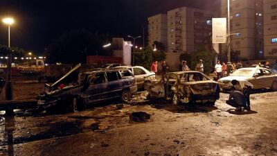 People look at the damage from a car bombing in the eastern Libyan city of Benghazi on May 25, 2018. Reuters