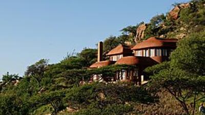 The Colonel's House is built into the side of a hill near a waterhole that attracts wild game.