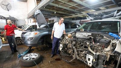 Mechanics work in a car repair garage, as Lebanon is gradually reopening its economy. Reuters