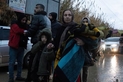 People evacuate their homes from near Khaled Ibn Al Waleed street. Anagha Nair for The National