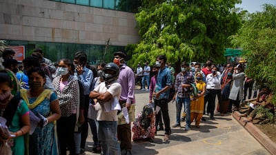 People wait for a Covid-19 test at a government hospital in Noida, a suburb of New Delhi, India. India reported more than 200,000 new coronavirus cases on Thursday, skyrocketing past 14 million overall as an intensifying outbreak puts a grim weight on its fragile health care system. AP Photo