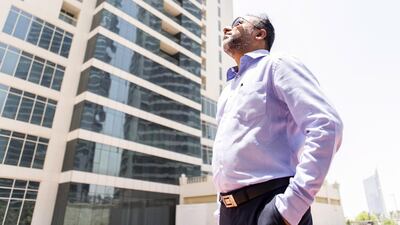 A Tamweel Tower apartment owner surveys the 34-storey building in Jumeirah Lakes Towers. Reem Mohammed / The National
