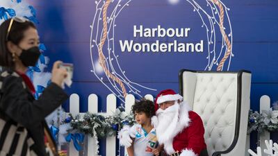 A child poses with Santa Claus at the Harbour Wonderland Christmas market at Dubai Harbour. All photos: Ruel Pableo for The National