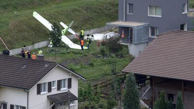 A small plane on the ground at the scene of a crash in Dittingen, Switzerland on August 23, 2015. One pilot was reported dead after two aeroplanes from a German stunt flying group crashed at a Swiss air show, according to local police. Georgios Kefalas/EPA