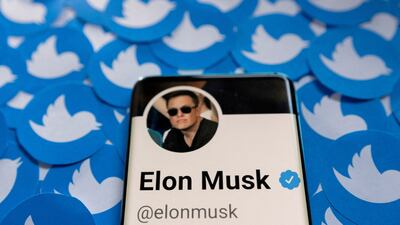 Elon Musk's Twitter profile on a smartphone placed on printed Twitter logos. Mr Musk is set to buy the social media platform. Reuters