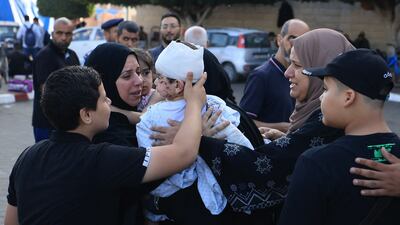 A woman hold a injured toddler following the Israeli bombardment of Deir Balah in the central Gaza Strip, at the Shuhada Al Aqsa hospital, on November 6 AFP