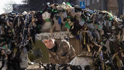A Ukrainian serviceman stands guard at a military check point in the centre of Kyiv. AFP