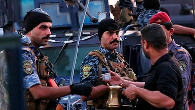 A street vendor sells coffee to members of the Iraqi Federal police as they deployed in Sadr City, Baghdad, Iraq. Iraq's prime minister on Monday ordered the police to replace the army in Sadr City, a heavily populated Shiite neighborhood of Baghdad where dozens of people were killed or wounded in weekend clashes stemming from anti-government protests. AP Photo