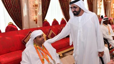 Sheikh Mohammed bin Rashid congratulates Abdulla Sultan Alaryani - who won three silver medals in shooting - at the 2016 Rio Paralympic Games in Brazil. Wam