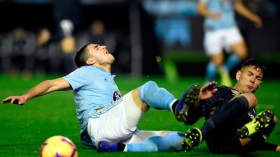 Celta Vigo forward Maxi Gomez, left, tussles with with Real Madrid defender Javi Sanchez. AFP