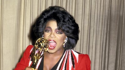 Oprah Winfrey wears a red jacket over a black buttoned dress to attend the 14th Annual Daytime Emmy Awards on June 30, 1987. Getty Images