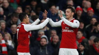 Alexis Sanchez, left, and Mesut Ozil, right, both shone for Arsenal in the win over Tottenham Hotspur on Saturday. Paul Childs / Reuters