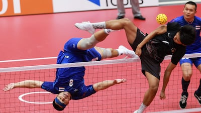 Thailand's Pichet Pansan, left, in action during a sepak takraw match against Indonesia at the Asian Games in Nagoya, Japan. AFP