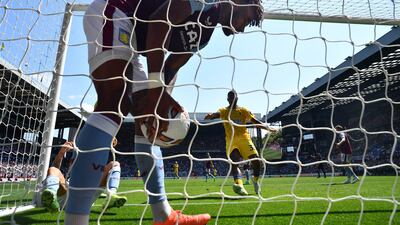 Aston Villa's Tyrone Mings picks the ball out of the net after Lucas Digne scored an own goal. Reuters