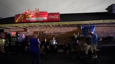 Outside Arabi Food store, New Orleans residents gather. Some have been displaced from their damaged homes. AP Photo