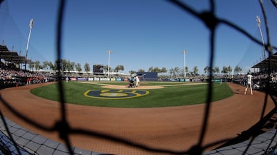 Milwaukee Brewers' Logan Morrison hits against Cincinnati Reds pitcher Sal Romano during the fifth innings of a Major League Baseball spring training game in Pheonix on Sunday, March 1. AP