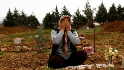 Emine Onal cries by the grave of her daughter, who was killed in the earthquake 15 days after having started her first job as a nurse in a Turkish state hospital. Reuters