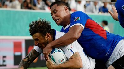 Italy full back Matteo Minozzi, left, dives and scores a try at the Hanazono Rugby Stadium. AFP
