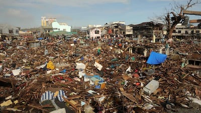 Typhoon Haiyan survivors participate in a “cash for work” programme, cleaning debris from houses in Tacloban, Leyte province. Noel Celis / AFP