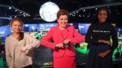 Scotland's First Minister Nicola Sturgeon (C) poses for a photograph as she meets climate activists Vanessa Nakate (R) and Greta Thunberg. AFP