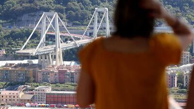 A woman look at the collapsed Morandi Bridge in the Italian port city of Genoa on August 16, 2018. Reuters