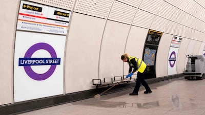 A cleaner works on a platform at Liverpool Street station in London during a test run of the new Elizabeth Line train service between Paddington station and Liverpool Street on Wednesday. AFP