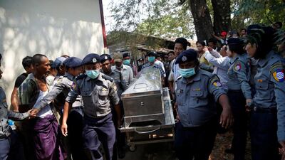 Police carry a victim’s body to Pathein General Hospital after a boat with 60 passengers returning from a wedding struck a barge and capsized in Pathein river, Myanmar, yesterday. Soe Tun / Reuters