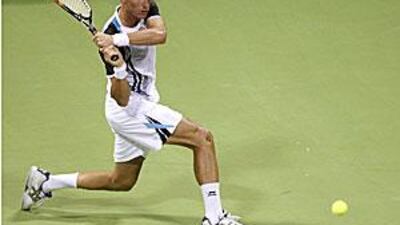 Russia's Nikolay Davydenko returns a shot to Roger Federer of Switzerland during their semi-final match in Doha.