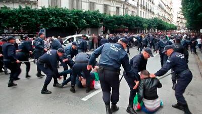 This AFPTV screen grab from a video shows Algerian security forces detaining protesters during an anti-government demonstration in the capital Algiers on the day of the presidential election. About 10,000 protesters rallied in Algeria's capital against presidential elections they believe aim to perpetuate the regime of deposed leader Abdelaziz Bouteflika, AFP reporters witnessed. The crowd outnumbered police who had intervened with force and made several arrests in a bid to prevent a mass demonstration of the almost 10-month old "Hirak" protest movement. AFP