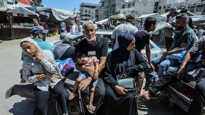 Palestinians travel on trailer drawn by a taxi in Khan Younis, southern Gaza. AFP