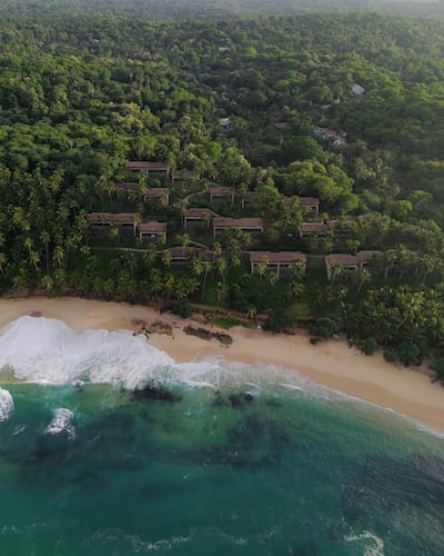 The secluded resort is surrounded by coconut trees and a small stretch of beach. Photo: Amanwella