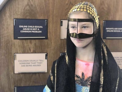 A young Russian visitor to the Aqdar World Summit tries on a "Gulf burqa" and an abaya at the UAE exhibition in Moscow. Balquees Basalom / The National