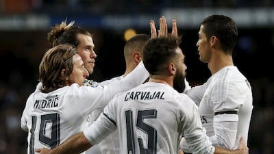 Gareth Bale, second left, is congratulated by his Real Madrid teammates after scoring against Deportivo La Coruna. Susana Vera / Reuters