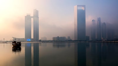 Morning fog brings an eerie perspective to the Corniche in Abu Dhabi. Victor Besa / The National