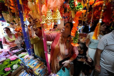 People shop on the eve of Diwali, the Hindu festival of lights, in Jammu. Diwali spending trends have remained strong this year that bodes well for Indian economy. AP Photo